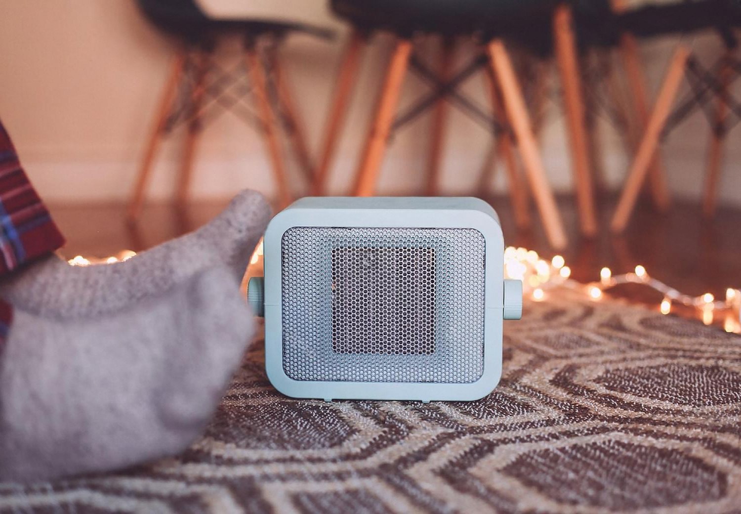Compact portable air cooler running on a patterned rug in a UAE home