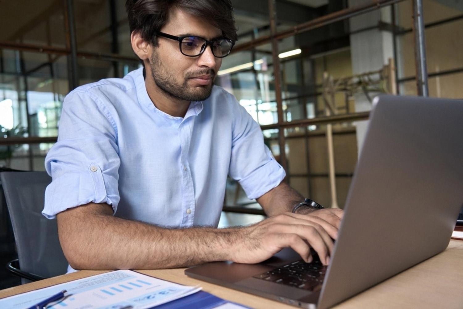 UAE professional at a laptop analysing company reports and financial charts